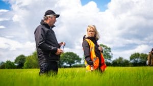 Ron Granger and Heather Oldfield standing in a cereal crop.