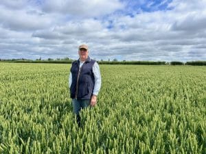 Richard stood in a field of crops