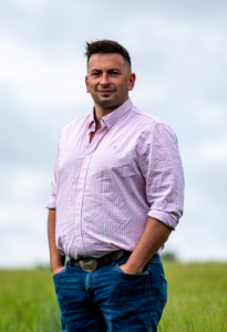 Ryan McCormack standing in a crop field.